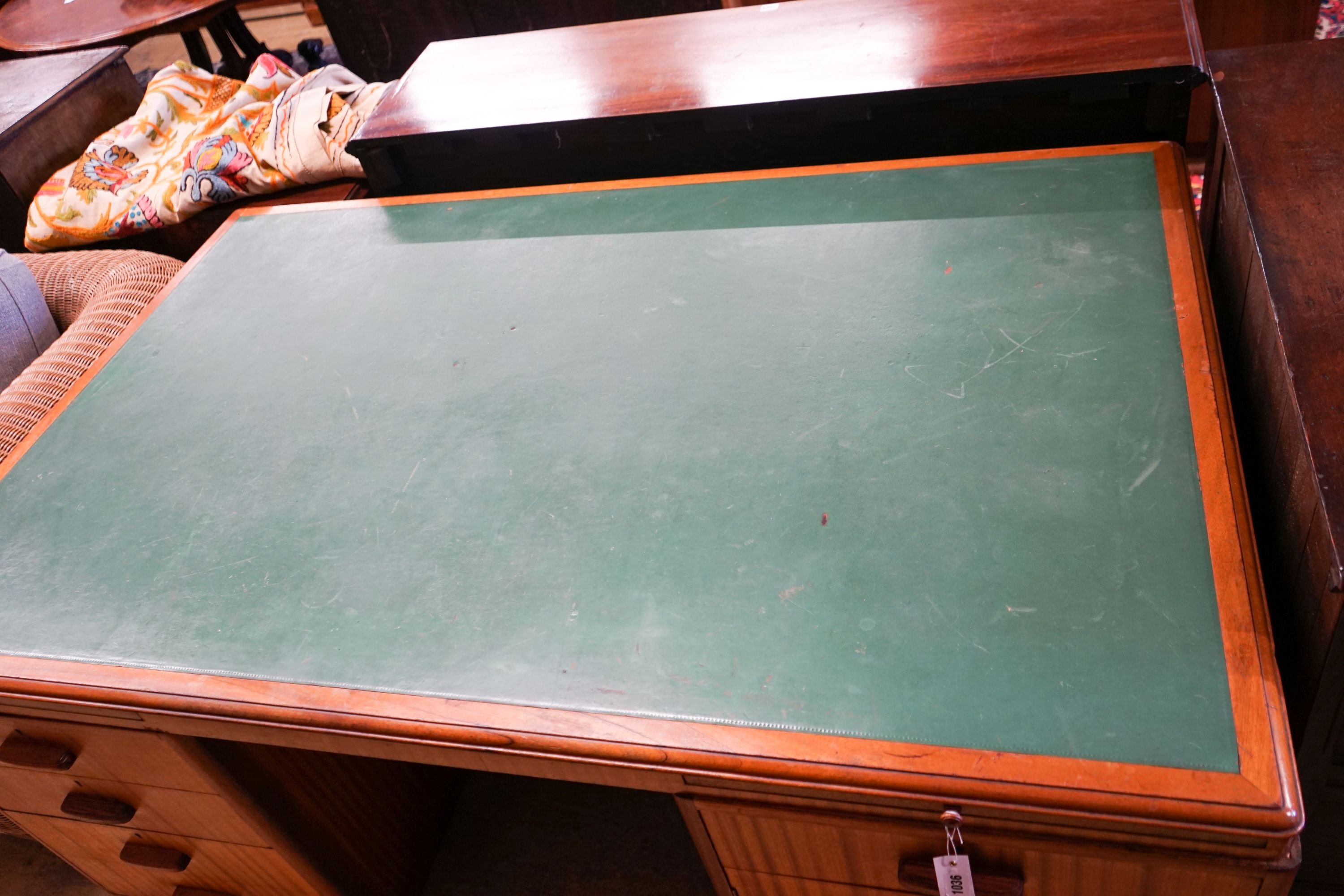 A mid century design teak kneehole desk, bears a Waring & Gillow stamp, length 168cm, depth 106cm, height 74cm